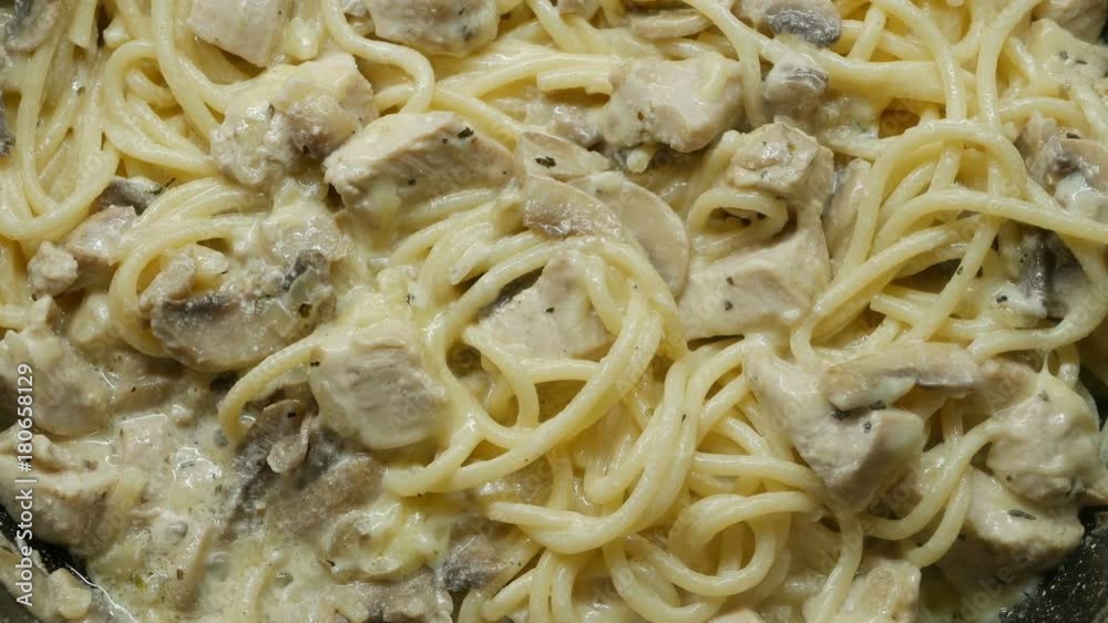 4K, dish of pasta, cooked to tradition with white sauce, mushrooms and chicken 4K, dish of pasta, cooked to tradition with white sauce, mushrooms and chicken