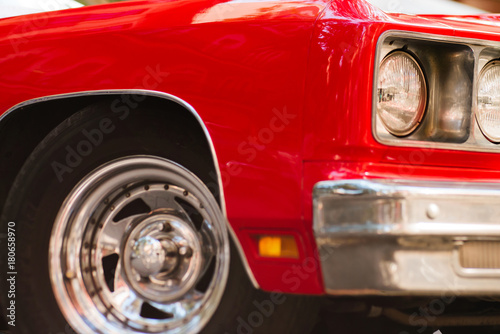 Close-up of headlights of red vintage car © bodiaphoto