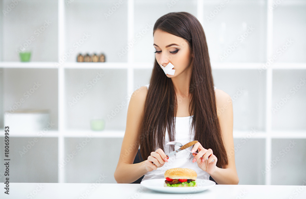 Diet. Portrait woman wants to eat a Burger but stuck skochem mouth, the concept of diet, junk food, willpower in nutrition Diet. Portrait woman wants to eat a Burger but stuck skochem mouth, the concept of diet, junk food, willpower in nutrition