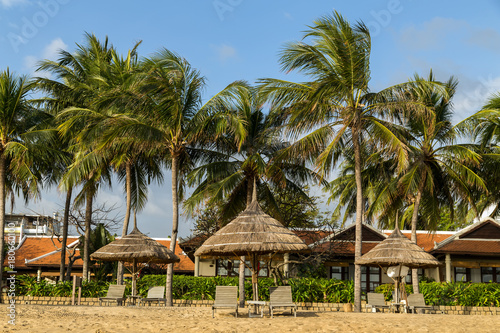 Deckchairs parasol on the tropical sand summer beach