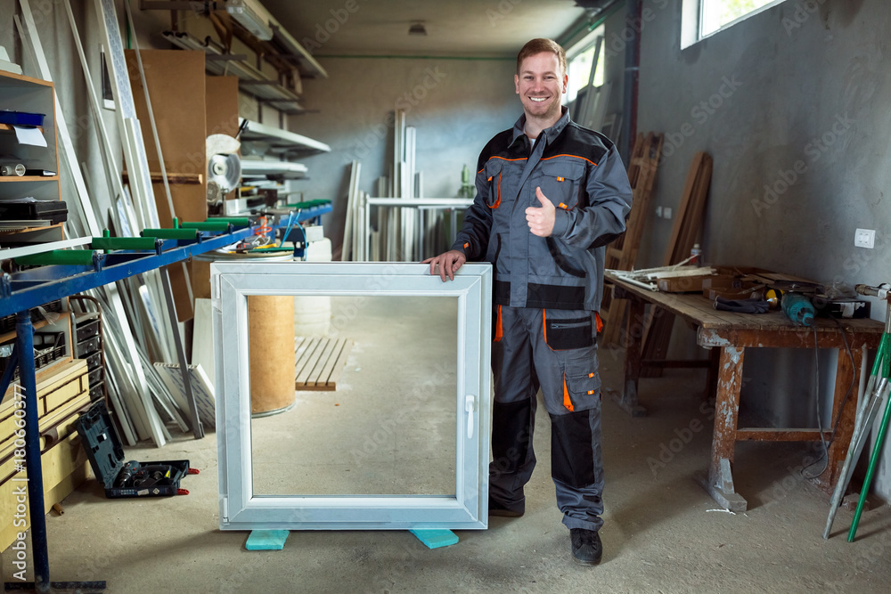 Worker in workshop for manufacture of windows and doors