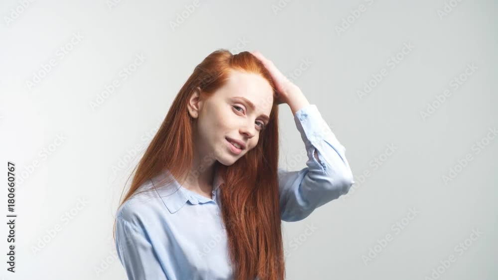 Portrait of young attractive redhead girl smiling looking at camera. Isolated on white background. Portrait of young attractive redhead girl smiling looking at camera. Isolated on white background.