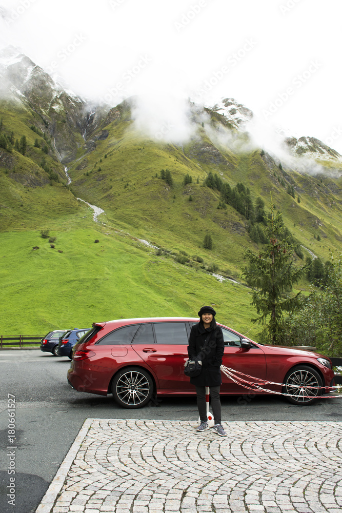 Asian thai old woman posing for take photo with Alps mountain in car parking at Samnaun village
