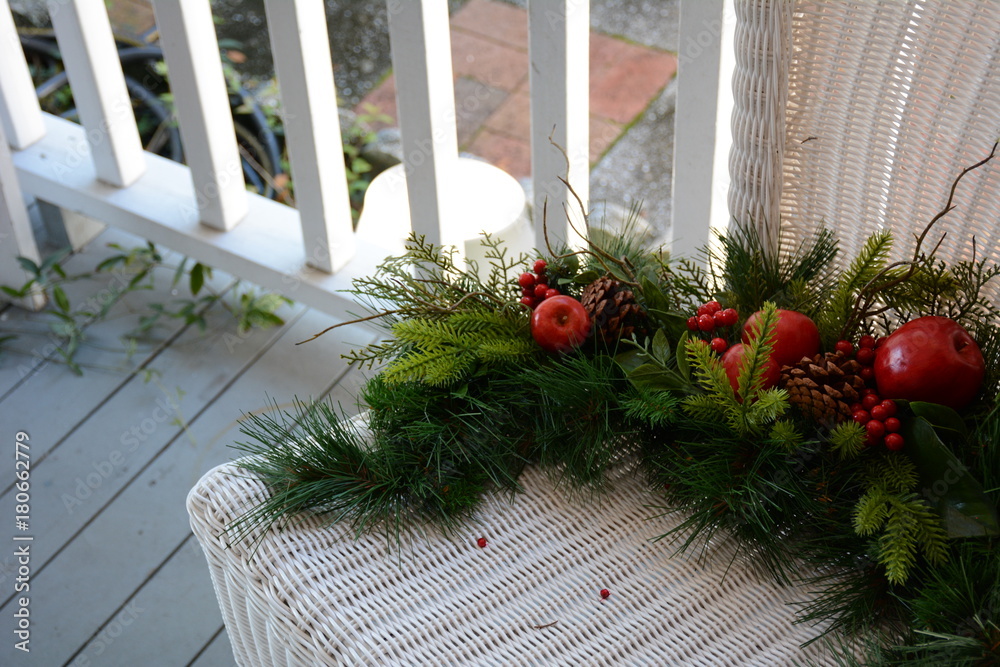 Evergreen Christmas Decoration on White Wicker Chair