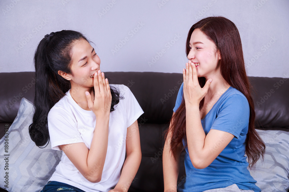 happy two woman with talking on sofa at home happy two woman with talking on sofa at home