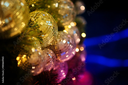 close up mirror ball or Christmas ball to decorative for Christmas festival with bokeh colorful tone background. Have some space for write wording