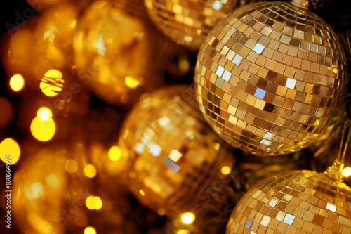 close up mirror ball or Christmas ball to decorative for Christmas festival with bokeh golden tonebackground. Have some space for write wording