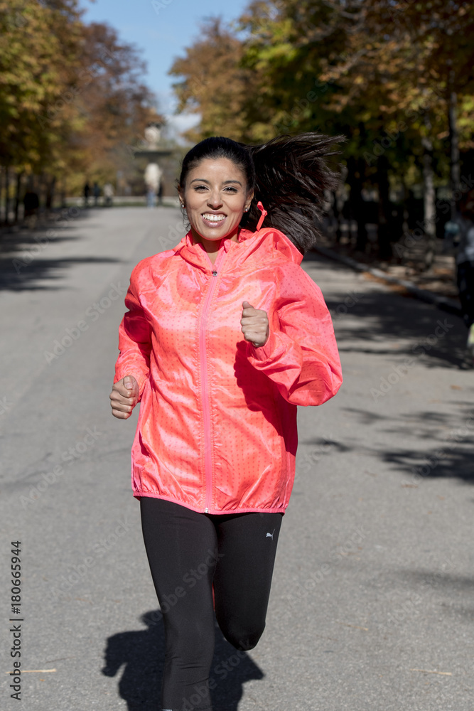 Fototapeta premium runner sport woman in Autumn sportswear running and training on jogging outdoors workout in city park smiling happy