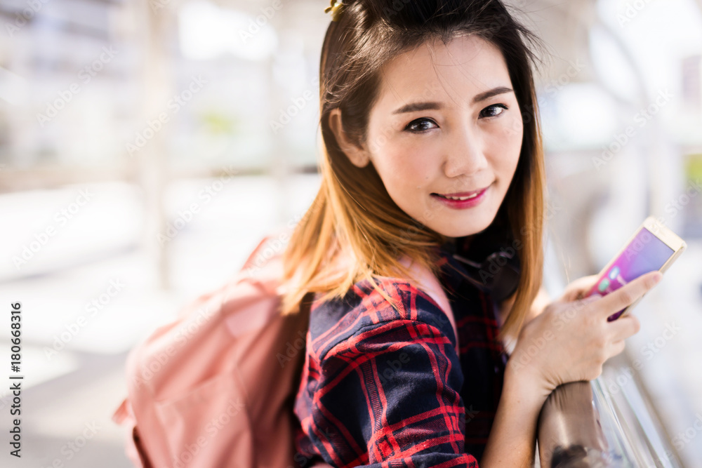 beautiful happiness young asian girl in casual dress traveling alone at train station or airport with backpack vintage tone photo concept beautiful happiness young asian girl in casual dress traveling alone at train station or airport with backpack vintage tone photo concept