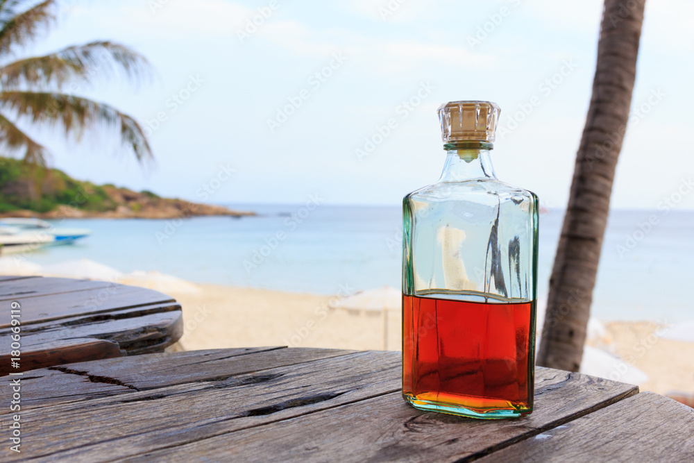 Beverrage alcohol is brandy bottle on wood table. - obrazy, fototapety, plakaty 