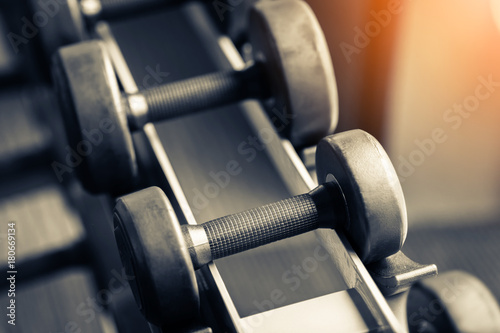 Rows of dumbbells in the gym with hign contrast and color tone sport and health concept