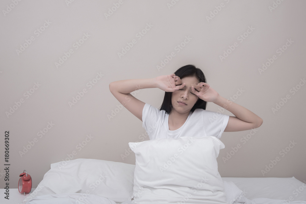 Happy beautiful woman stretching smiling with closed eyes sitting on bed at home woke up in the morning. Happy beautiful woman stretching smiling with closed eyes sitting on bed at home woke up in the morning.