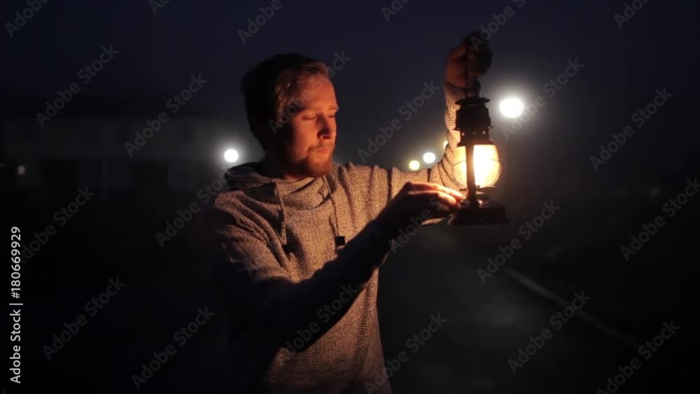 man with a kerosene lantern on a foggy street man with a kerosene lantern on a foggy street