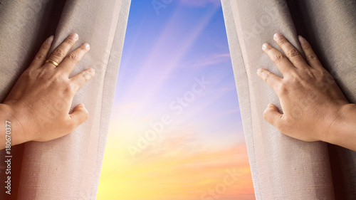 Man and hope concept . man opening window curtains and seeing the beautiful sky