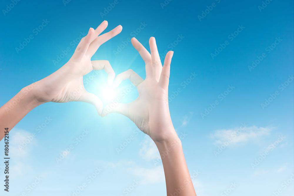 two hands making a heart shape in the blue sky two hands making a heart shape in the blue sky