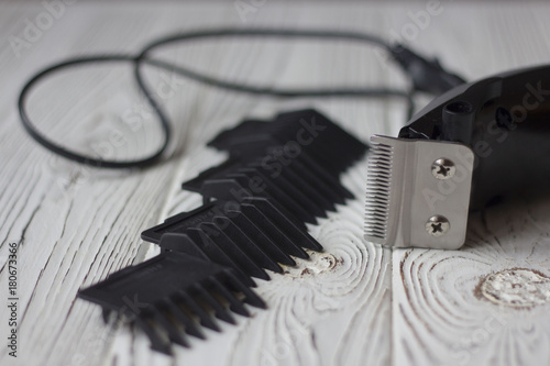 Fotografi electric clipper hair clipper and attachments on wooden background