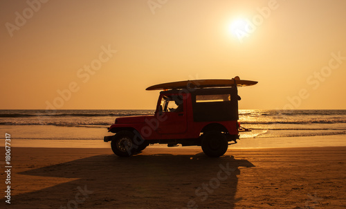 Surf rescue vehicle on beach at sunset