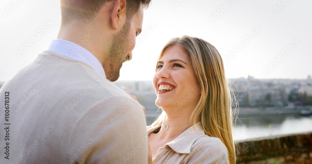 Couple kissing in city during sunset Couple kissing in city during sunset