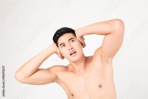 Man with head ache feeling pain. Studio shot on white background. Fitness and health concept