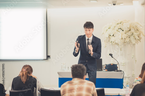 Businessman giving a talk on corporate Business Conference. Audience at the conference hall. Business and Entrepreneurship event.