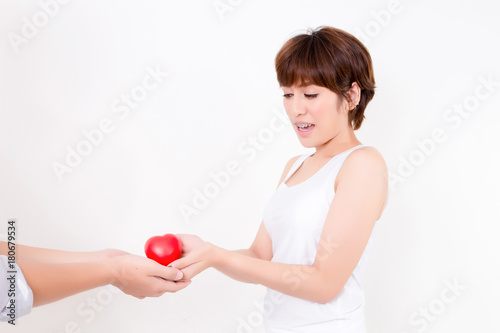 Man give the red heart to the young asia woman. Isolated on white background. Studio lighting. Concept for healthy.