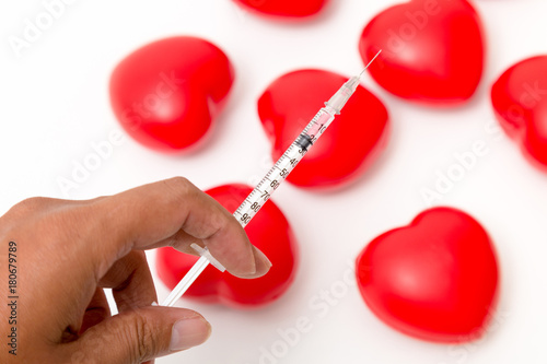Syringe with Red heart . Isolated on white background. Studio lighting. Concept for healthy and medical