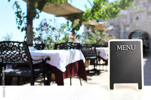 Mock up Menu blackboard with Restaurant Cafe Shop Interior blurred Background