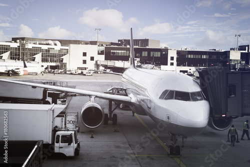 Airport terminal and aircraft with apron, waiting for passenger, doing service maintenance