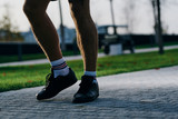 athlete's feet, on the sidewalk