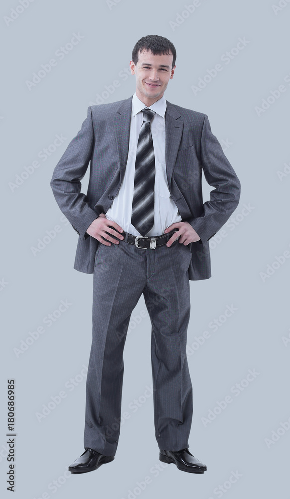 Full-length portrait of a confident businessman isolated on gray