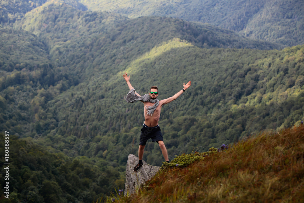 handsome guy on mountain slope handsome guy on mountain slope