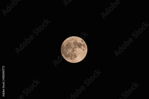 Full yellow moon on dark sky background