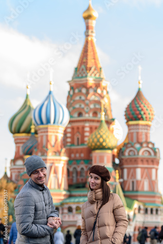 Photography Stylish couple on the red square on the background of St