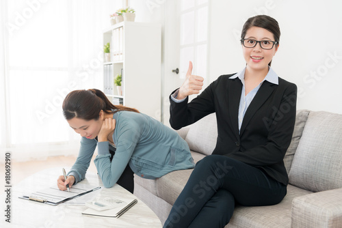 girl writing undersigned on insurance document