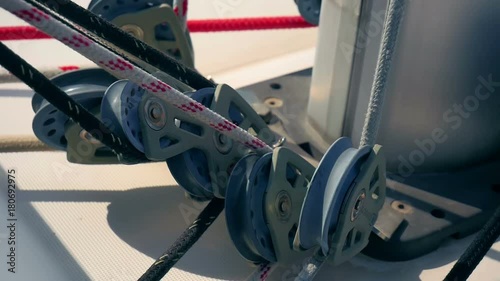 CROATIA, ADRIATIC SEA, 2017.11.07: Ropes going through different pulleys beside sailing boats main mast. Filmed in slow motion hd.
