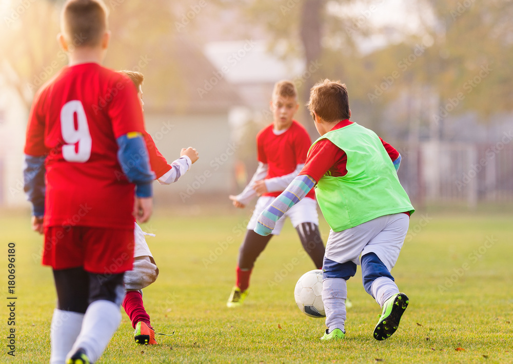 Young children players football match on soccer field