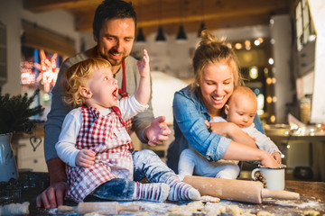 Young family making cookies at home.