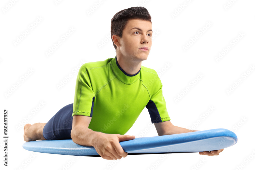 Teenage boy lying on a surfboard Teenage boy lying on a surfboard