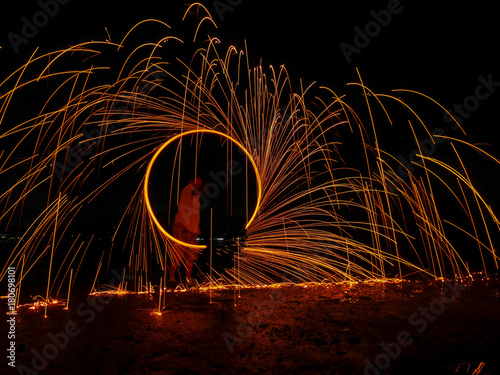 light lines of steel wool with long exposure, speed motion abstract background in the dark night