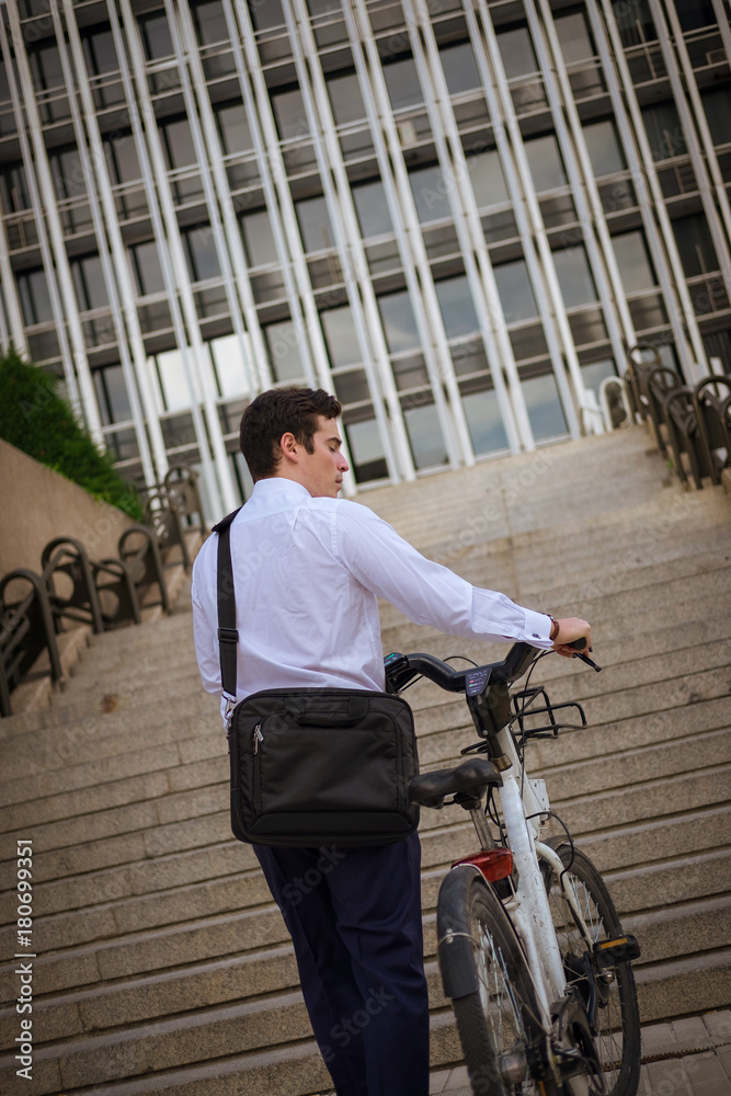 Young buinessman riding to work in the city Young buinessman riding to work in the city