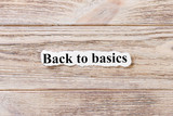 Back to Basics of the word on paper. concept. Words of Back to Basics on a wooden background