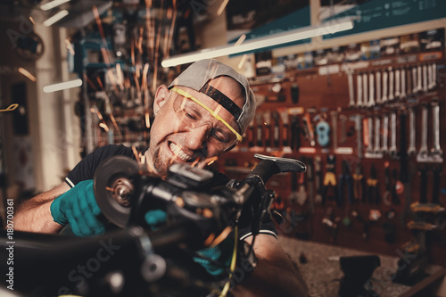 Bicycle mechanic in a workshop in the repair process