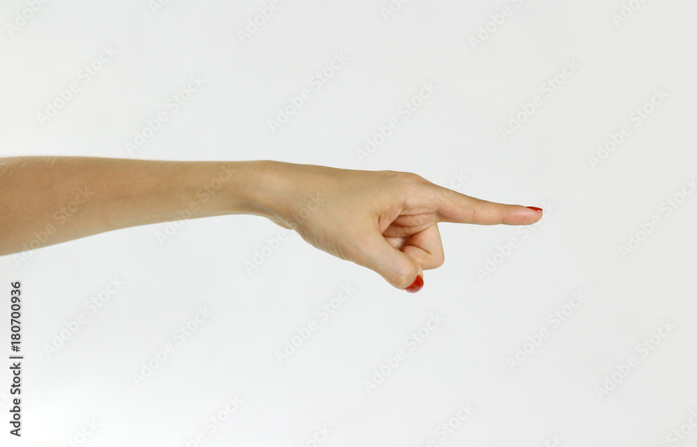 Female hand shows the direction. Isolated on gray background. Closeup. Female hand shows the direction. Isolated on gray background. Closeup.