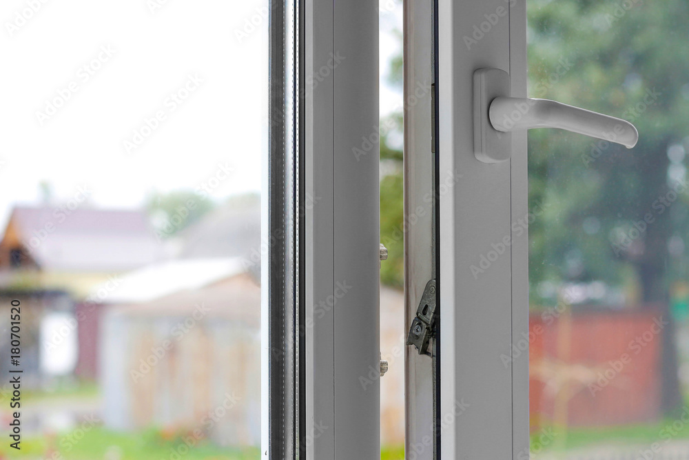 Open white plastic window. In the sanny weather. Closeup Open white plastic window. In the sanny weather. Closeup