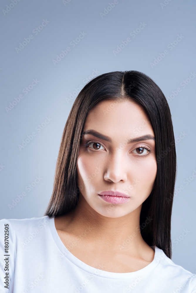 Fashionable model. Amazing beautiful experienced photo model looking concentrated on the working process while posing for a famous fashionable magazine Fashionable model. Amazing beautiful experienced photo model looking concentrated on the working process while posing for a famous fashionable magazine