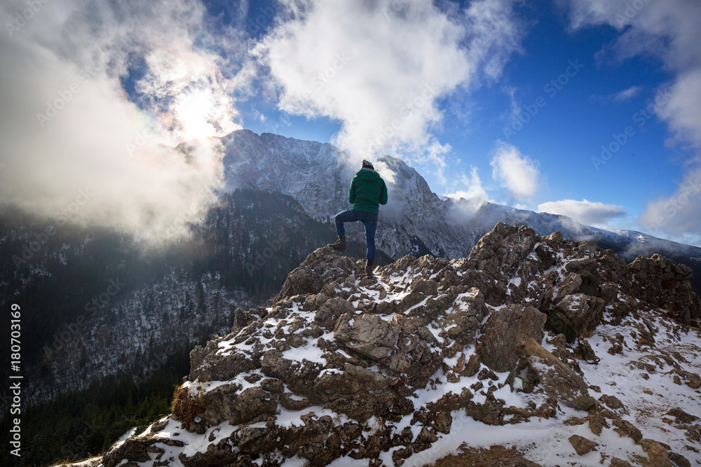 Naklejka premium Hiker standing on the top of a hill in Tatra mountains, Poland