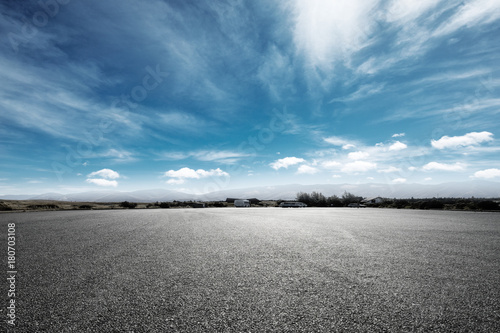 empty asphalt road with snow mountains in blue cloud sky © zhu difeng