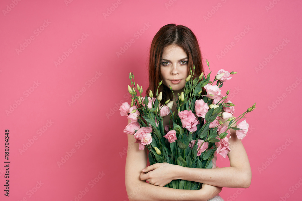 girl holding two bunches of flowers