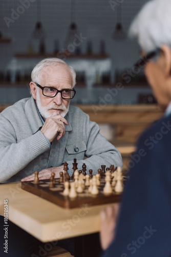 senior men playing chess