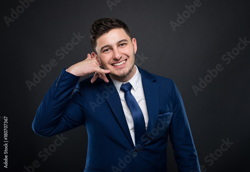 Attractive businessman is showing hand phone